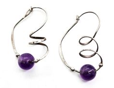 Amethyst purple beaded Artisan sterling silver twisted spiral vintage hoop earrings. Good used condition with little to no signs of normal wear. Beautiful purple amethyst beads have two small sterling silver beads on each side of the stone. Beautiful artisan sterling twist on the face of the hoop. Acid tests positive for sterling silver. Gemstone tested with Presidium II Gemstone tester. Earring measure 1 and 1/4 of an inch tall and 7/8ths of an inch deep. Handmade Swirl Jewelry With A Modern Twist, Handmade Sterling Silver Earrings With A Modern Twist, Handmade Purple Spiral Jewelry, Amethyst Purple, Amethyst Beads, Sterling Silver Bead, Purple Amethyst, Guinea Bissau, Mozambique