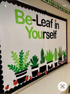 a sign that says be - leaf in yourself on the side of a wall with plants and ladybugs