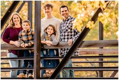 a family standing on a bridge in the fall