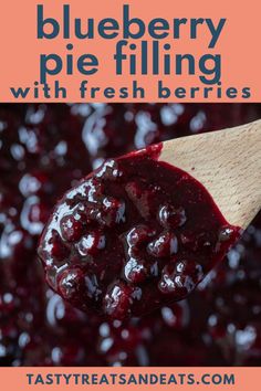 blueberry pie filling with fresh berries in a wooden spoon and text overlay reads, blueberry pie filling with fresh berries