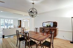 a dining room table with chairs and a chandelier