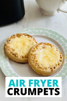 two biscuits on a plate with the words air fryer crumpets