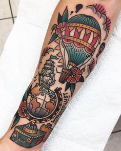 a person with a hot air balloon tattoo on their arm