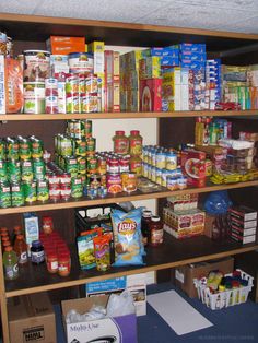 the shelves are full of various food items, including canned foods and other condiments