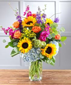 a vase filled with lots of colorful flowers