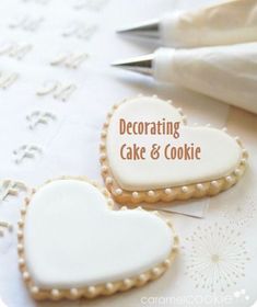 two decorated cookies sitting on top of a table