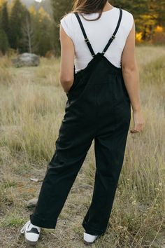 Introducing our Callum Overalls in black! Featuring a relaxed fit, adjustable straps, and front pockets, these overalls are both stylish and functional. The raw hem detail along the sides and back add an edgy touch, while the cinched sides offer even more detail. Perfect for your everyday look! *Relaxed fit* Material Content: 60% Cotton // 40% Polyester Material Pattern: Solid Kirsten is 5'4" wearing a small Model measurements: Kirsten: Height: 5'4" // Chest: 32" // Waist: 24" // Hips: 27" Amand Black Cotton Jumpsuits And Rompers With Adjustable Straps, Casual Black Jumpsuits And Rompers With Adjustable Straps, Black Overall Jumpsuit With Adjustable Straps, Black Overalls With Adjustable Straps, Black Jumpsuit With Adjustable Straps, Black Overalls With Suspenders, Black Overalls With Adjustable Straps For Summer, Utility Overalls With Adjustable Straps For Everyday, Black Summer Overalls With Adjustable Straps