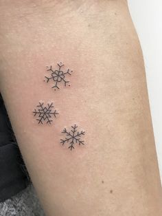 two small snowflakes on the arm