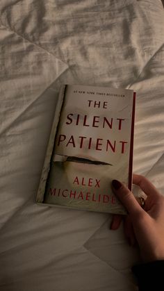 a person is reading a book in bed