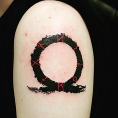 a black and red circle tattoo on the arm