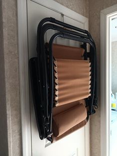 an over the door storage rack holds several rolls of toilet paper