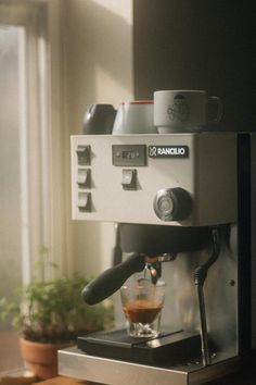 the espresso machine is being used to make coffee