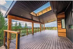 a wooden deck with railings and windows