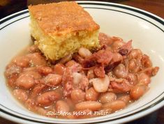 a white plate topped with beans and cornbread