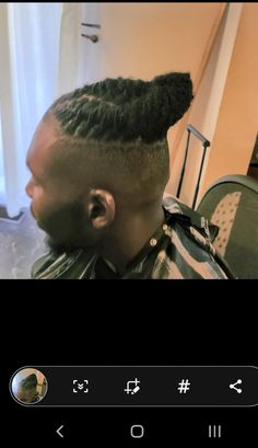 a man with long hair in a barbershop