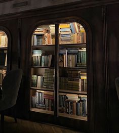 a room with bookshelves full of books and a chair in front of it