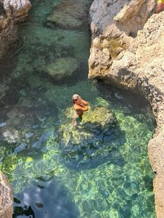 a man is swimming in the clear blue water