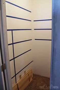 an empty room with blue lines painted on the wall