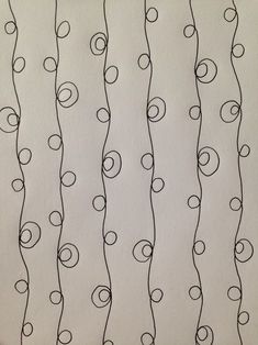 a drawing of black and white lines with circles drawn on the paper behind them,