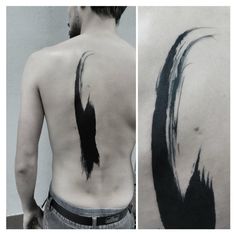 the back of a man's body with black ink on it and an image of a bird