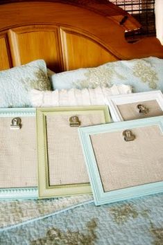 there are three frames on the bed and one has two clipboards attached to it