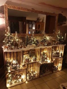 a christmas display with lights on it in front of a mirror and a wall mounted shelf