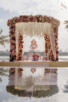 an outdoor ceremony setup with flowers and candles