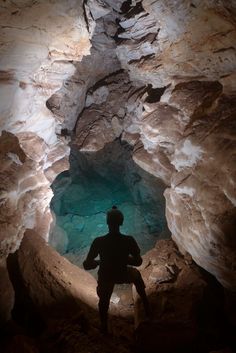 a person standing in the middle of a cave