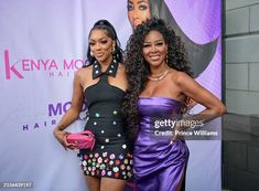 two women standing next to each other on the red carpet