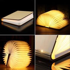 an open book shaped lamp sitting on top of a table