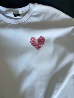 a t - shirt with a heart drawn on it