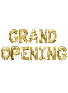 the words grand opening are gold foil balloons