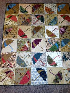 a patchwork quilt with umbrellas on it