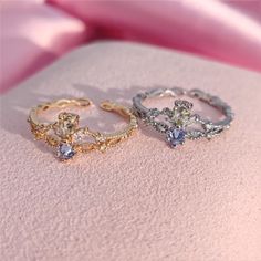 three different colored rings sitting on top of a pink blanket