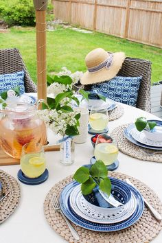 a table with plates, cups and vases on it