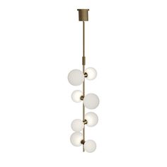 a brass chandelier with five white glass balls hanging from the bottom and one light on