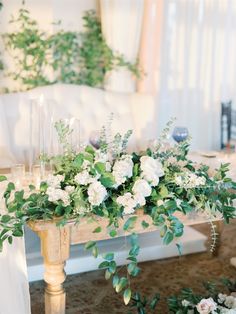 a table with flowers and candles on it