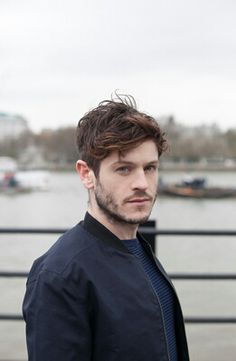 a man standing in front of a body of water