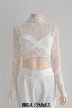 the back of a woman's wedding dress with lace on top and skirt below