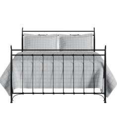 an iron bed frame with two pillows on it