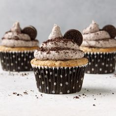 three cupcakes with oreo cookies and frosting