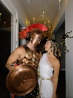 two women dressed in roman costumes standing next to each other