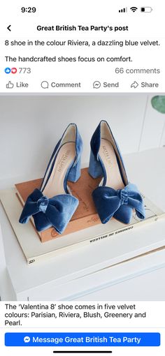 a pair of blue shoes with bows on them