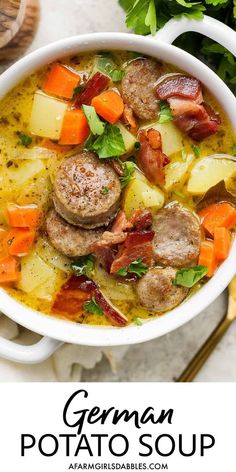 german potato soup with sausage and carrots in a white bowl