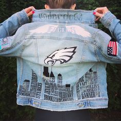 the back of a woman's jean jacket with an eagle and american flag on it