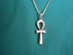 "Beautiful Egyptian Sterling Silver Ankh necklace. The ankh is an ancient Egyptian hieroglyphic symbol that was most commonly used in writing and in art to represent the word for \"life\" and, by extension, as a symbol of life itself. The sign has a cross shape but with an oval loop in place of an upper bar. It signified wisdom and insight on the highest level and it was also a fertility symbol. The ankh was widely used as an amulet in Ancient Egypt. Also commonly known as the \"cross of life\" Cheap Ankh Shaped Spiritual Jewelry, Cheap Ankh Shaped Metal Jewelry, Cheap Silver Ankh Necklace, Cheap Metal Ankh Jewelry, Ankh Egyptian, Egyptian Hieroglyphics Symbols, Egyptian Pendant, Fertility Symbols, Ancient Egyptian Hieroglyphics