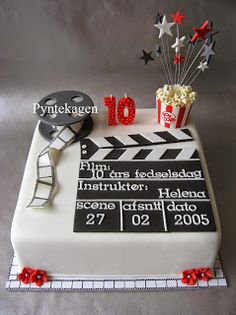 a birthday cake with a movie clapper, popcorn and stars on it for someone's 10th birthday