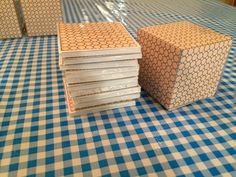 several pieces of paper sitting on top of a blue and white checkered table cloth