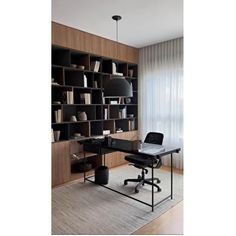 an office with a desk, chair and bookshelf