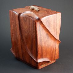 a wooden box with a leaf on the top and bottom, made out of wood